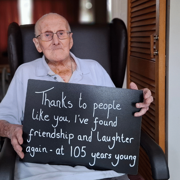 George holds a sign.