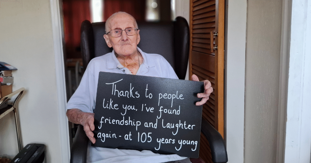 George holds a sign.